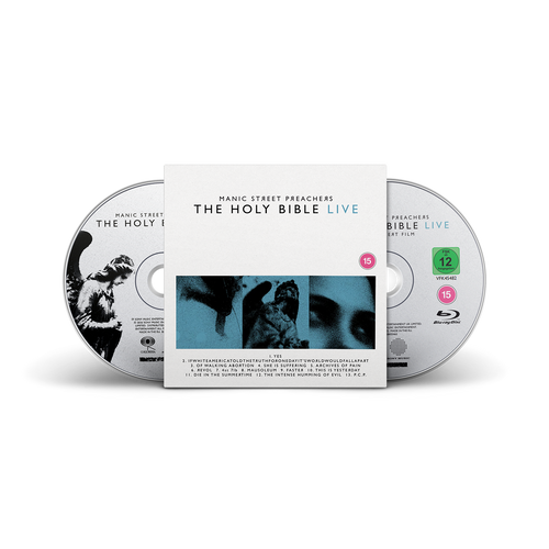 The Holy Bible Live 2-disc CD & Blu-ray set by Manic Street Preachers, featuring a white slipcover with blue and black imagery, flanked by one CD and one Blu-ray disc.